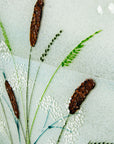 Close up of coastal grasses, hand-painted on a fused glass design with soft ocean colours. 