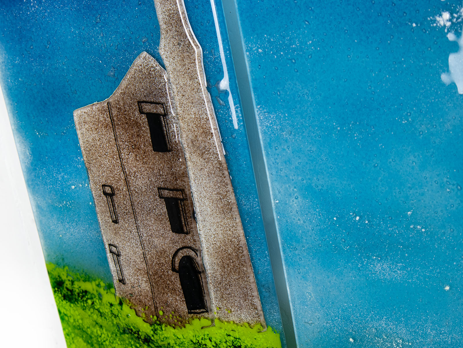 Close up of a Cornish tin mine on a fused glass triptych in coastal colours, a hand-made coastal wall art piece, with texture. 