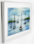 A hand-painted fused glass design of several sailboats anchored, designed in soft coastal colours and presented in a white frame.