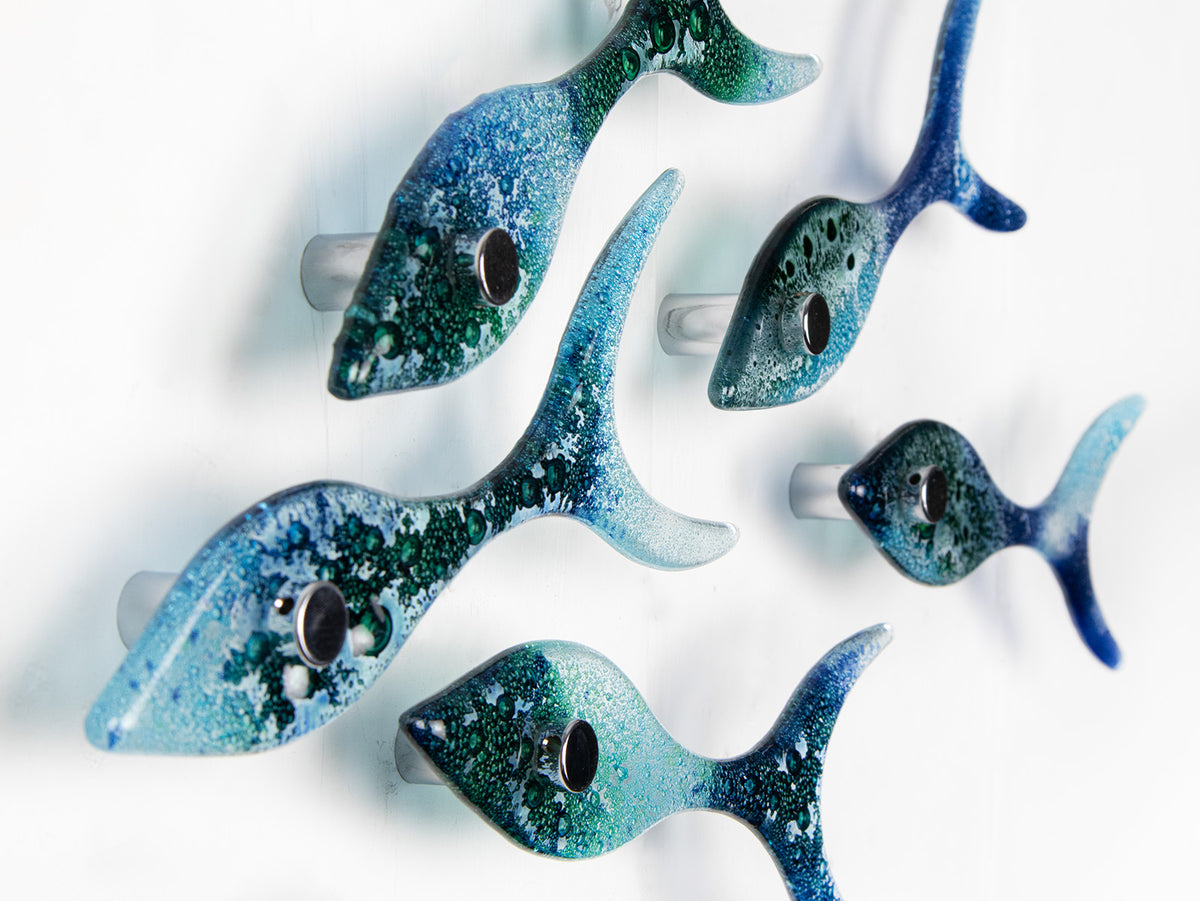 Side image of five fused glass fish, handmade in coastal colours, creating an ocean inspired wall art display.