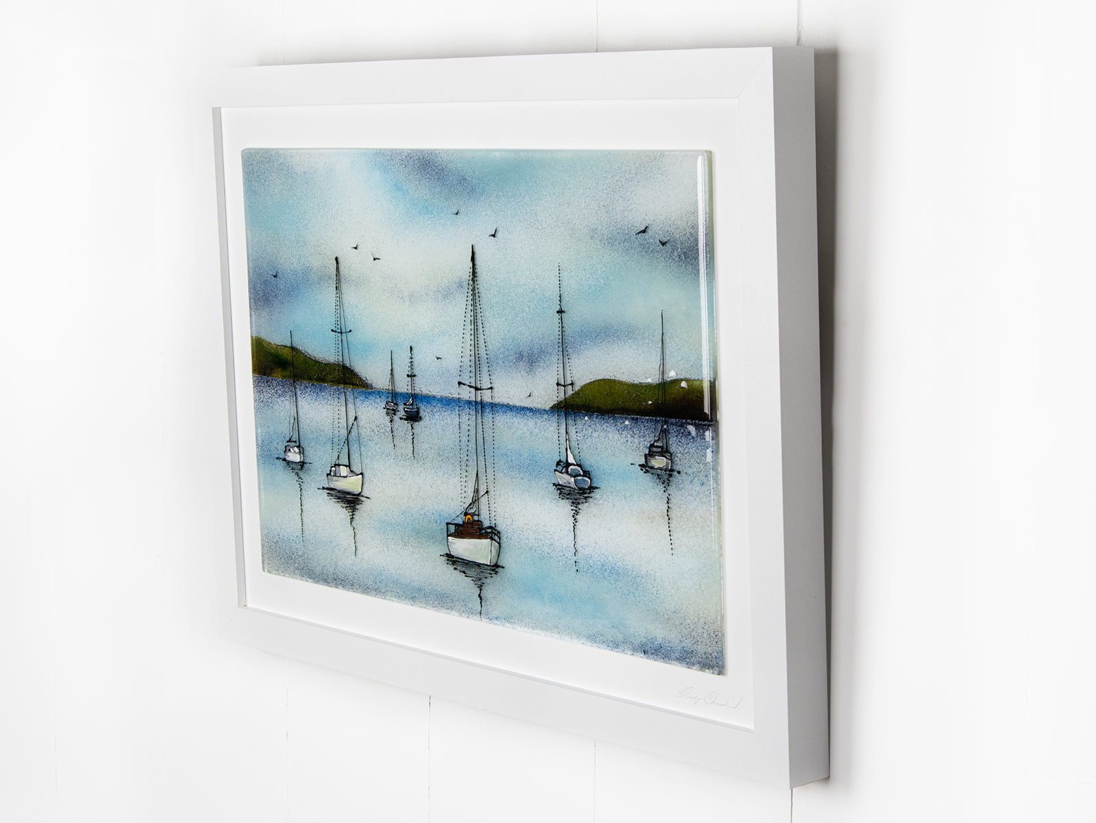 Side view of a fused glass art frame featuring hand-painted sailing boats entering a harbour with soaring birds in a soft coastal colour-way. 