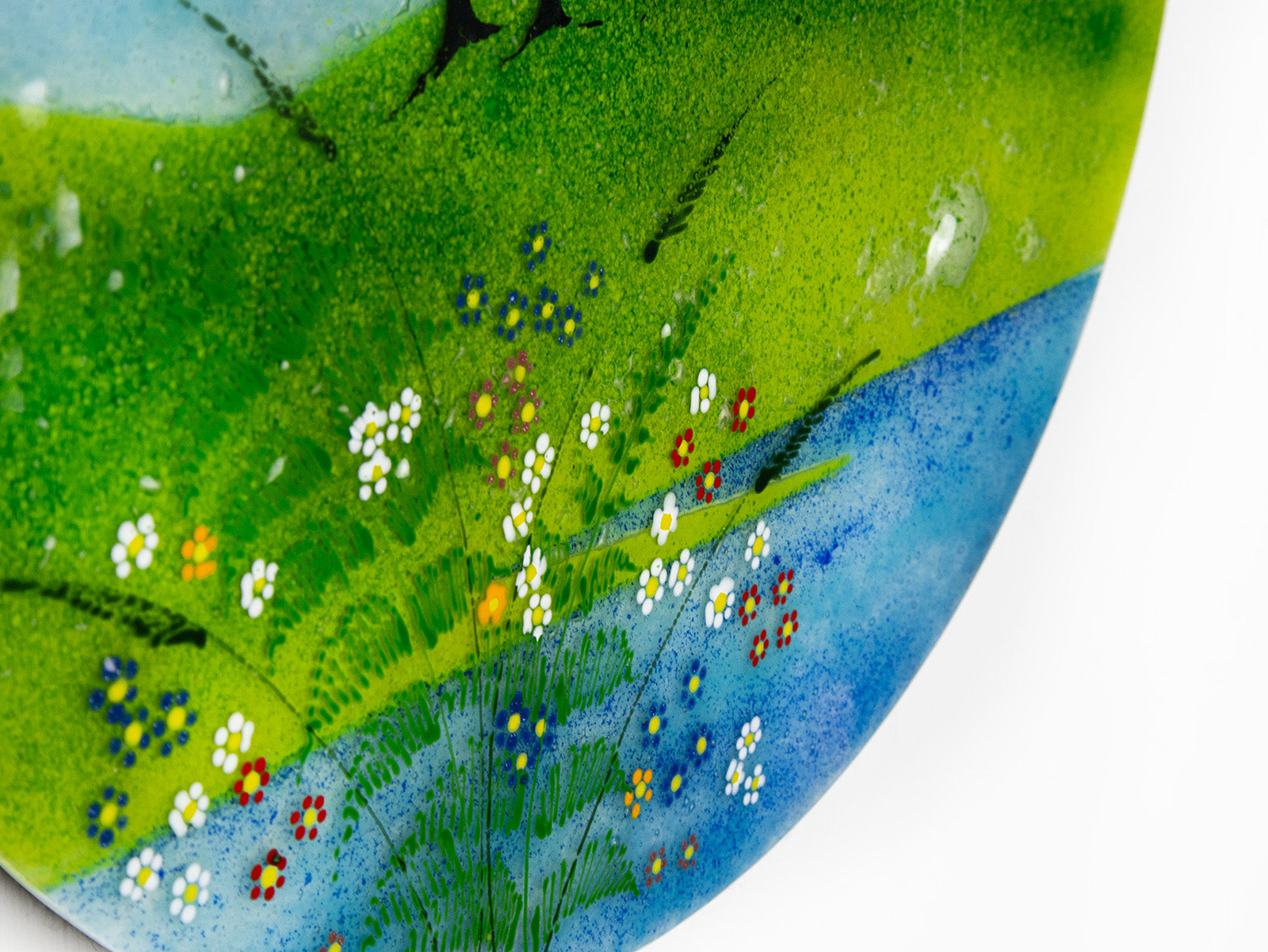 Floral detailing on a fused glass round panel, inspired by the Nearly Home Trees in Devon, designed in bright summer greens. 