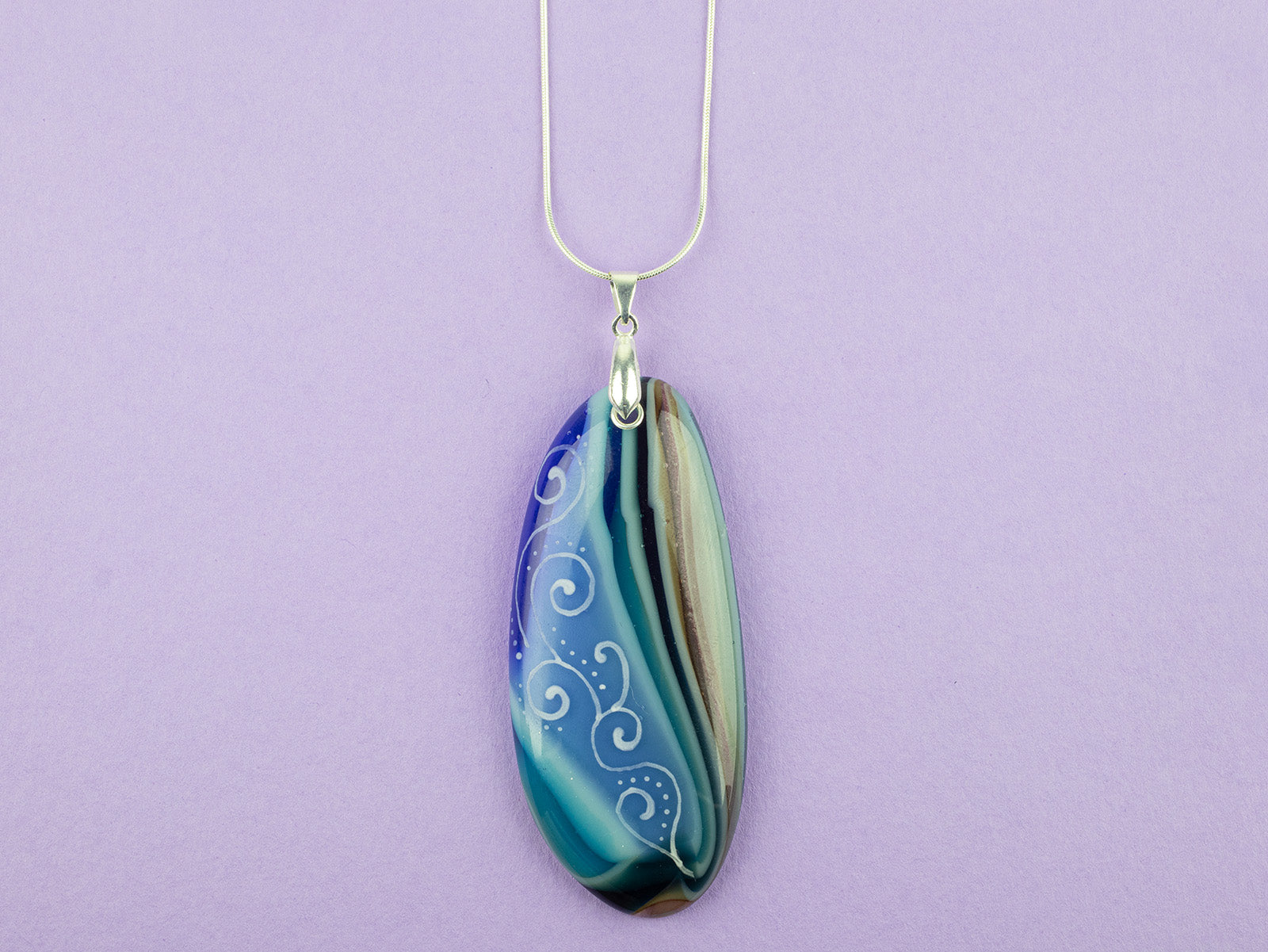 Fused glass pendant necklace, handmade in coastal hue, with an organic, swirling hand-painted design. 