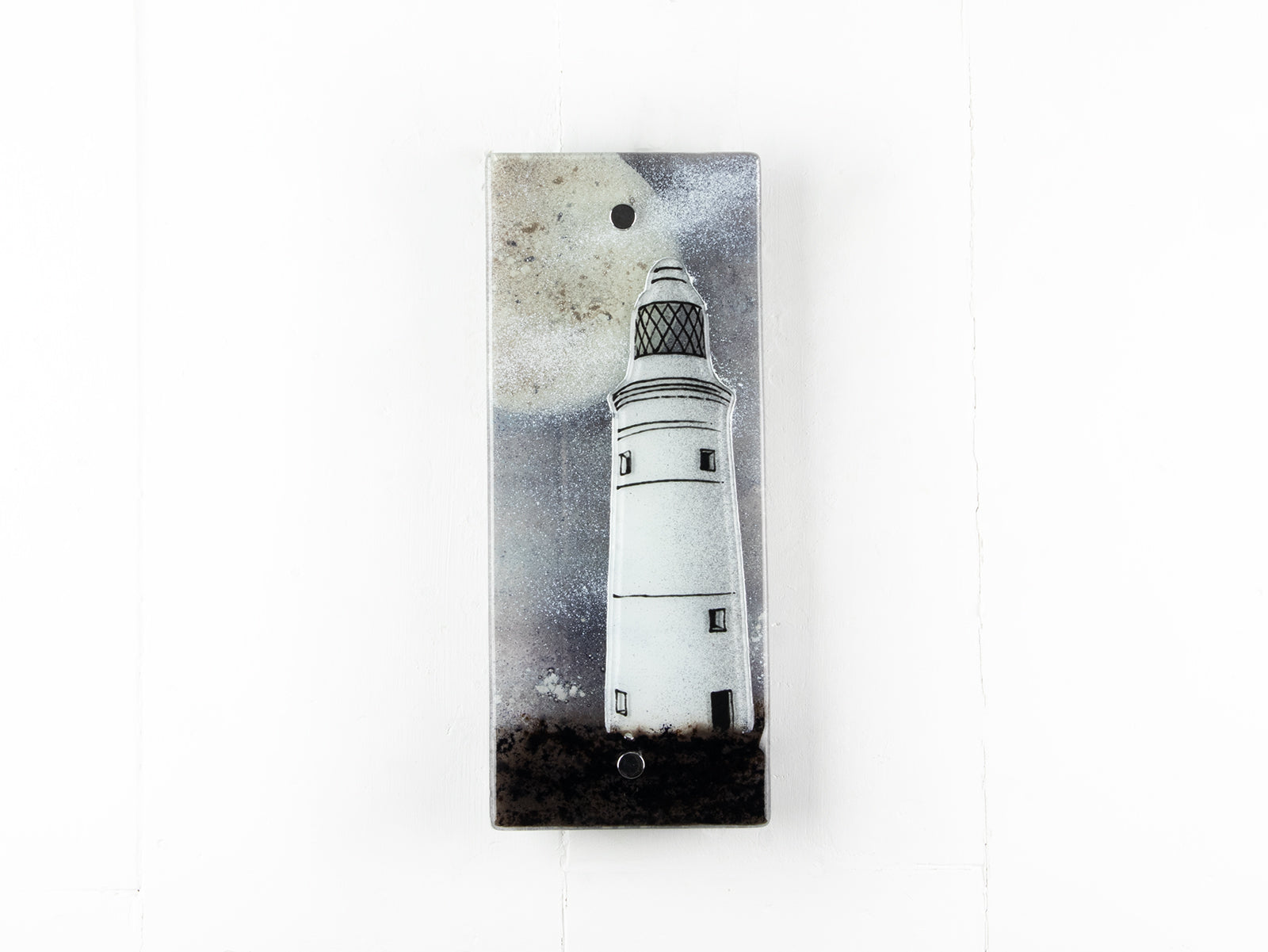 A fused glass extra small wall panel, featuring a lighthouse design with a full moon. A soft coastal piece of wall art. 