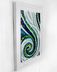 A fused glass large oblong art frame featuring an abstract tidal design in ocean blue and greens with textural detailing. A handmade coastal inspired piece of wall art. 