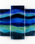 A fused glass quintych featuring an ocean blue colour-way, inspired by the coast.
