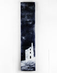 A fused glass panel featuring a monochrome design of a Cornish tin min. 