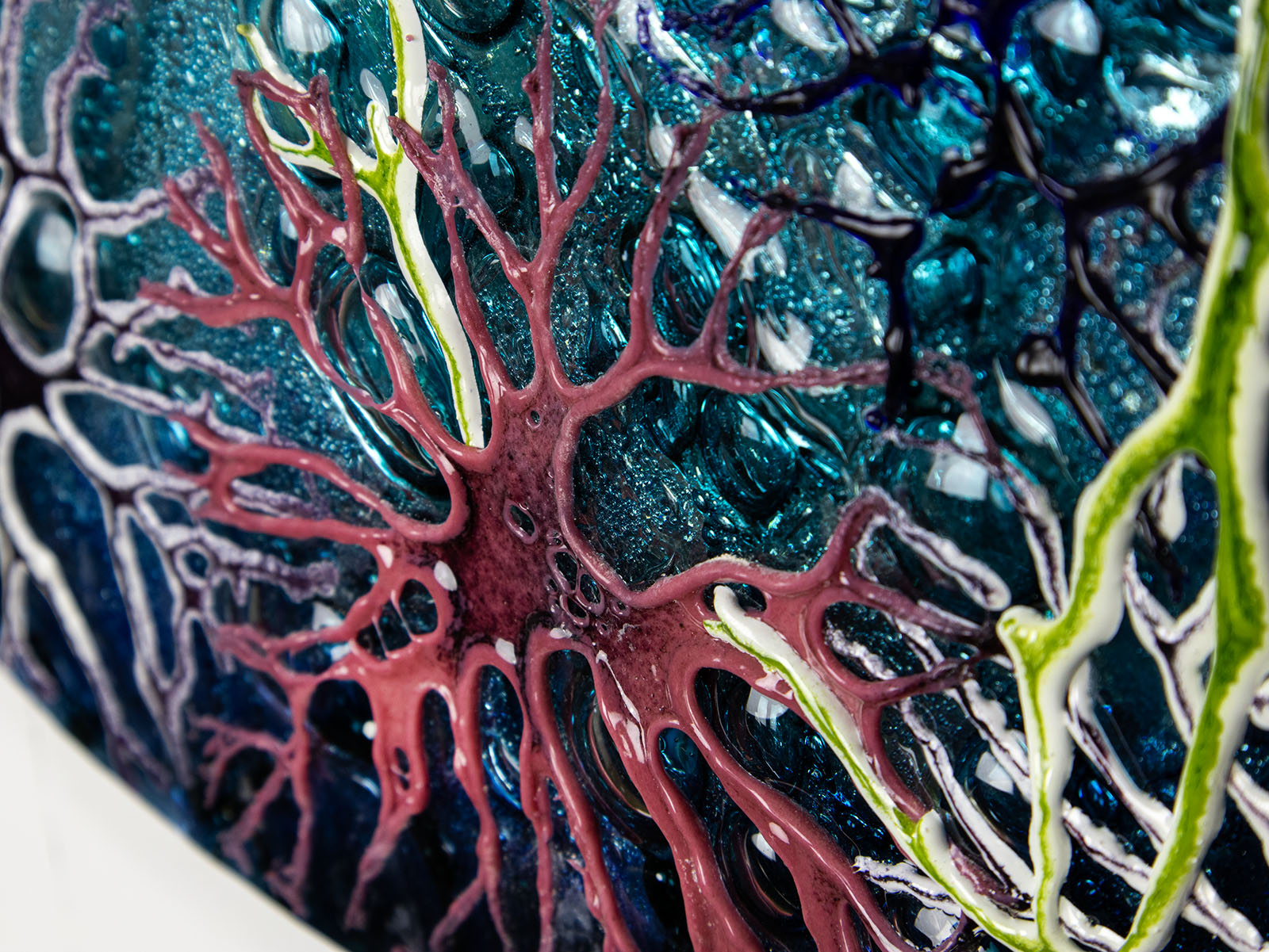 Organic details on a round fused glass wall panel, with hand-painted john dory design in vibrant organic colours and textures. 