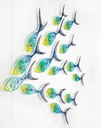Fused glass ocean shoal of fish, in bright coastal yellows, purples, greens and blues. A vibrant ocean inspired wall art display. 