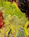 Close up of a fused glass round panel featuring organic autumn inspired patterns and shapes, in a vibrant yellow colour-way, handmade and inspired by the autumnal season. 