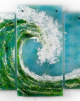A fused glass triptych featuring a giant ocean wave, with aqua and sea green colours and white texture. 