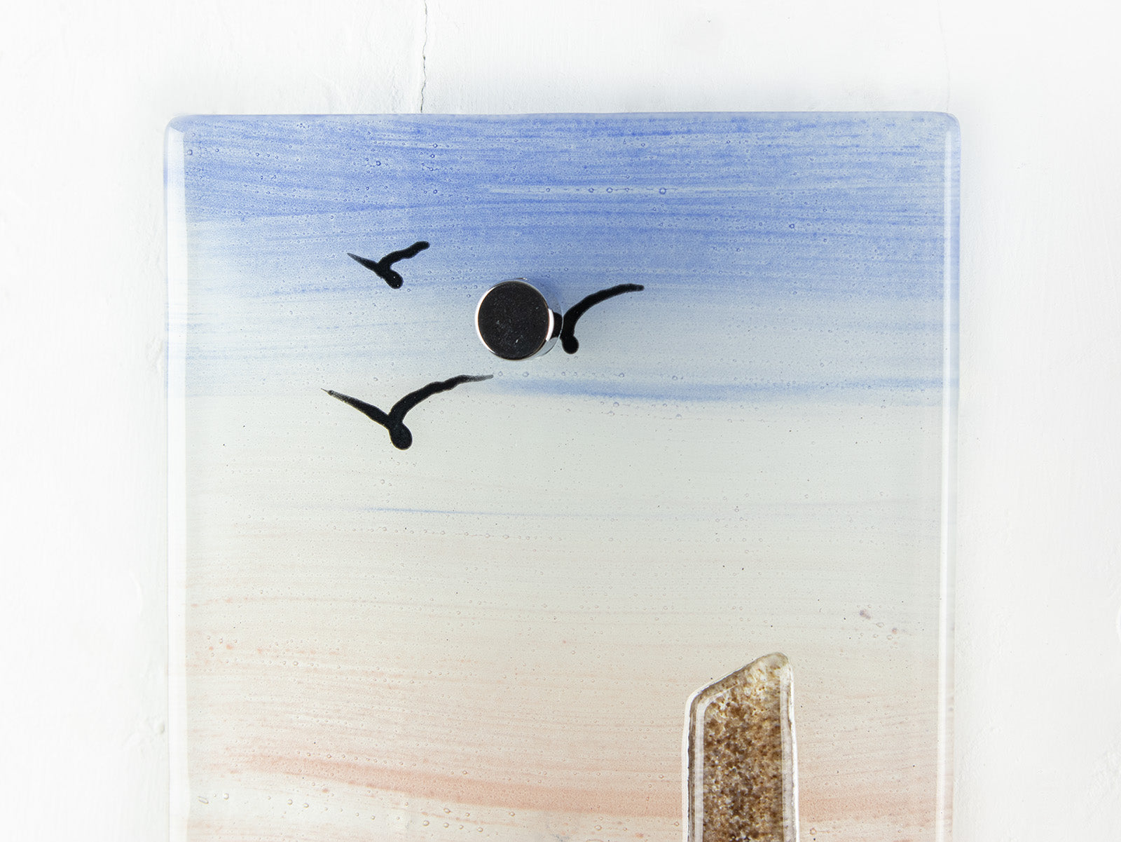 Close up of soaring birds as a silhouette on a fused glass extra small wall panel, featuring soft sunset sky, coastal landscape and a Cornish tin mine. 