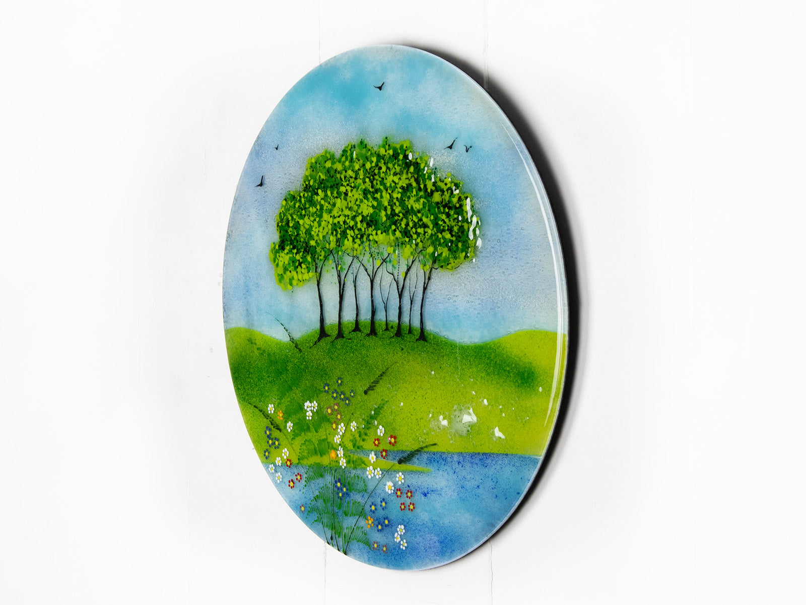 Fused glass round panel, inspired by the Nearly Home Trees in Devon, designed in bright summer greens. 