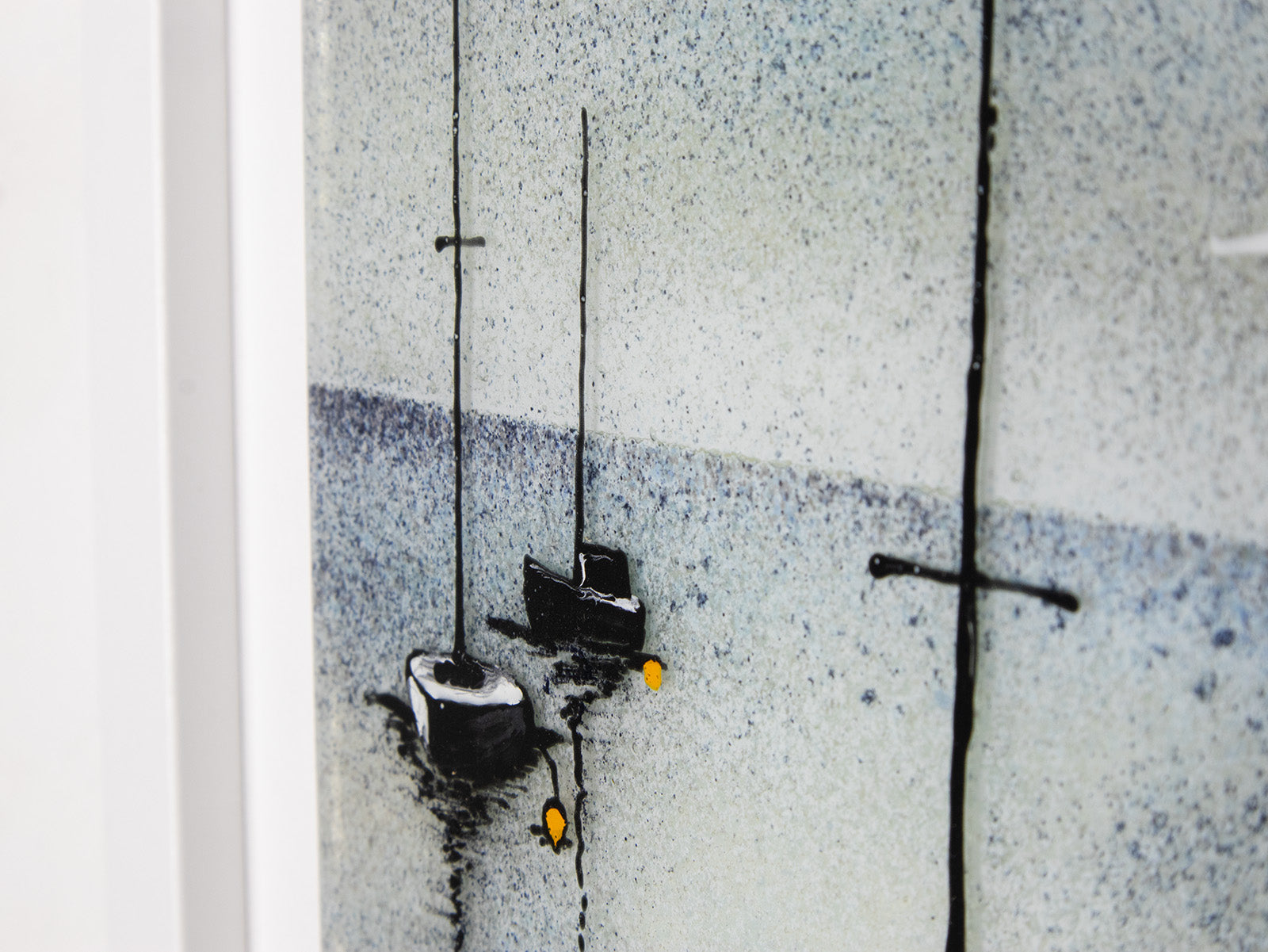 A close up of two boats on a fused glass oblong art frame with hand-painted sailboat design in a soft coastal colour-way. 