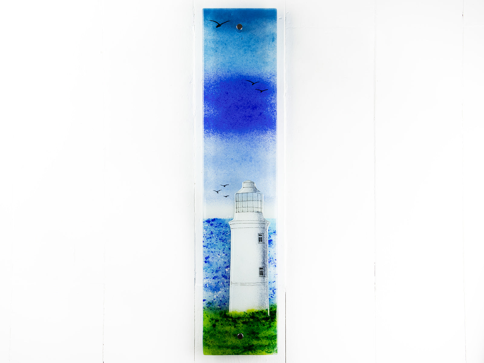 Fused glass wall panel with lighthouse design and soaring seagulls. Handmade made in Cornish studio in coastal colours.