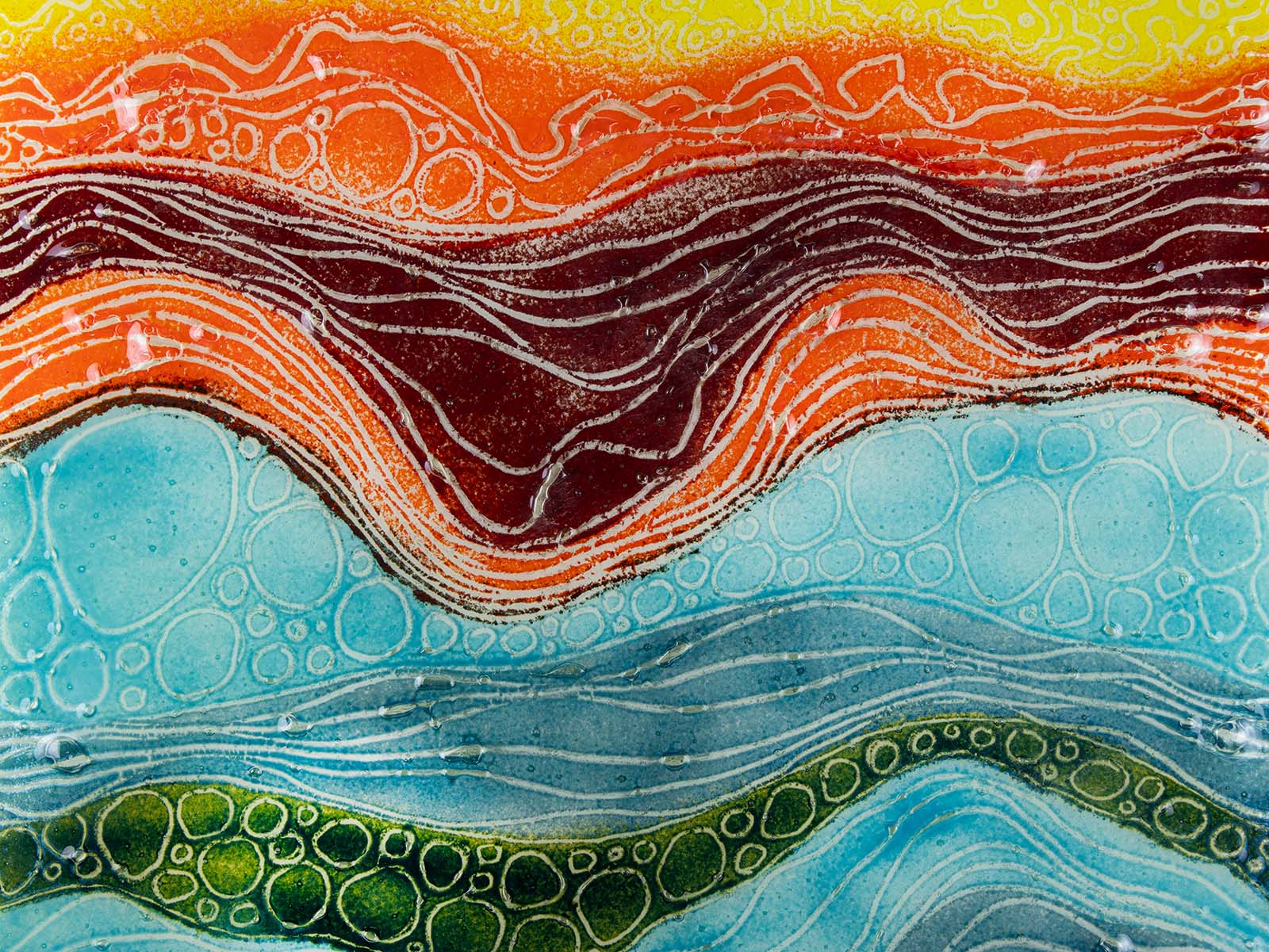 Close up of the details on a fused glass abstract, multi coloured square wall panel. 
