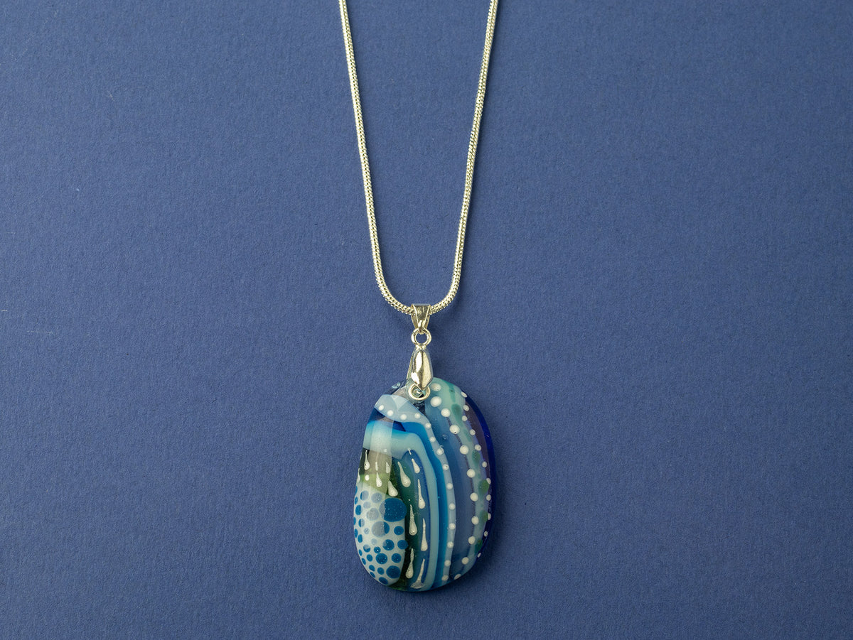 A signature by Jo Downs fused glass pendant necklace handmade using some of Jo's innovative techniques in rich ocean blues. Finished with a sterling silver chain and fittings. 
