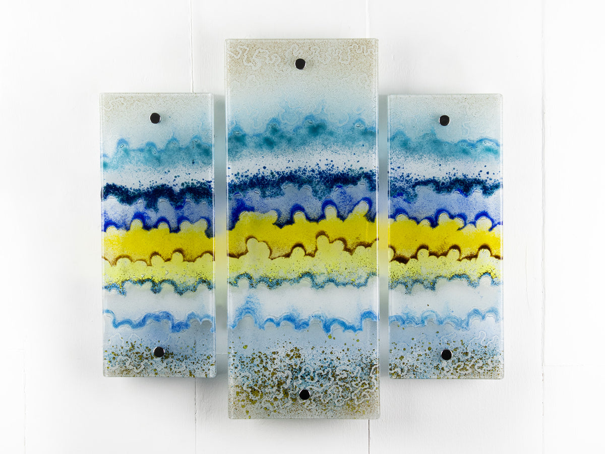 A fused glass small triptych wall art piece, handmade in coastal, soft, organic colours, inspired by the Cornish beaches.