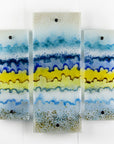 A fused glass small triptych wall art piece, handmade in coastal, soft, organic colours, inspired by the Cornish beaches.