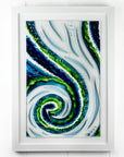 A fused glass large oblong art frame featuring an abstract tidal design in ocean blue and greens with textural detailing. A handmade coastal inspired piece of wall art. 