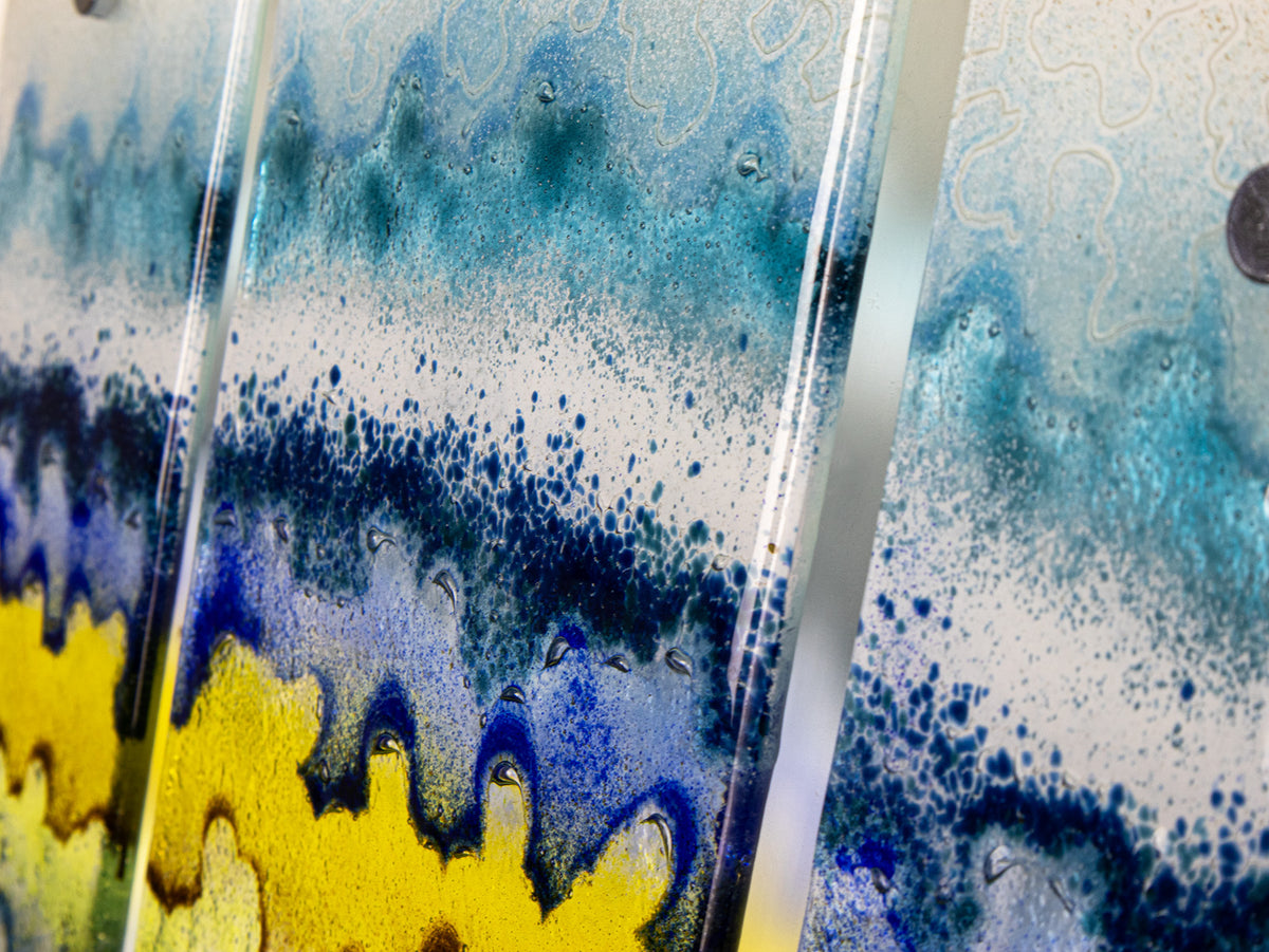 Details of a fused glass small triptych wall art piece, handmade in coastal, soft, organic colours, inspired by the Cornish beaches.