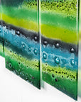 Fused glass triptych featuring an organic green design with bubbled detailing, handmade in emerald green colours. 