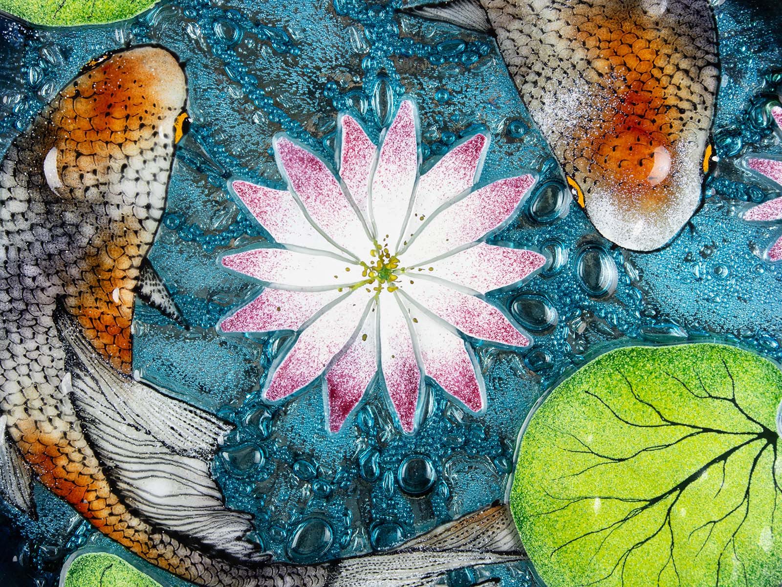 A close up of a fused glass round panel featuring hand-painted koi carp design with waterlilies and marine blue background. 