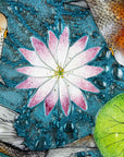 A close up of a fused glass round panel featuring hand-painted koi carp design with waterlilies and marine blue background. 