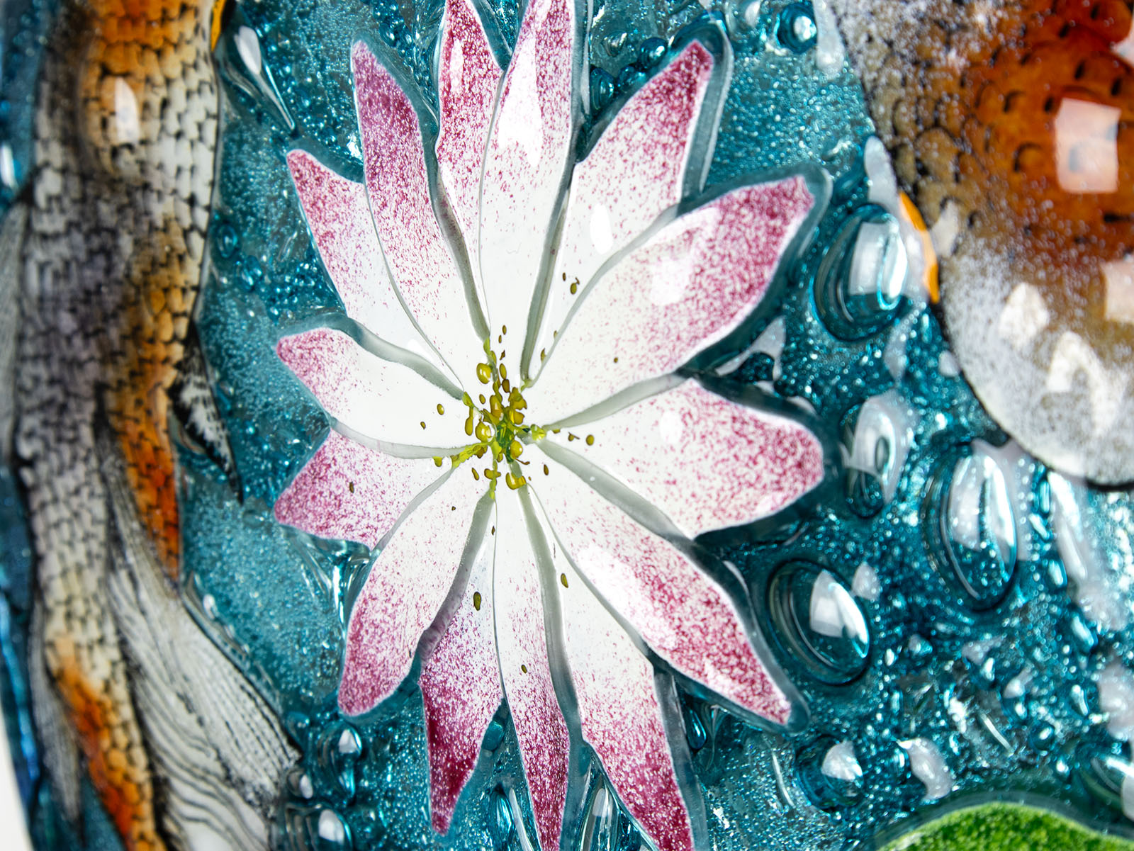 Details of a water lily on A fused glass round panel featuring hand-painted koi carp design with marine blue bubbled background. 