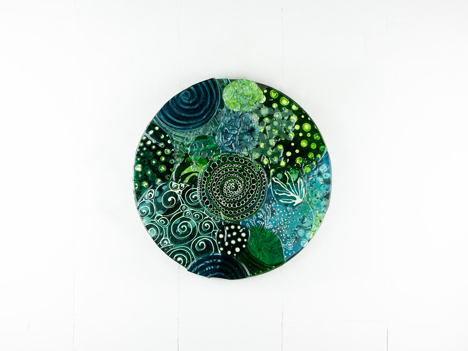 Fused glass round panel, handmade using ocean colours and botanical and organic painted designs. An abstract, coastal inspired piece of wall art. 