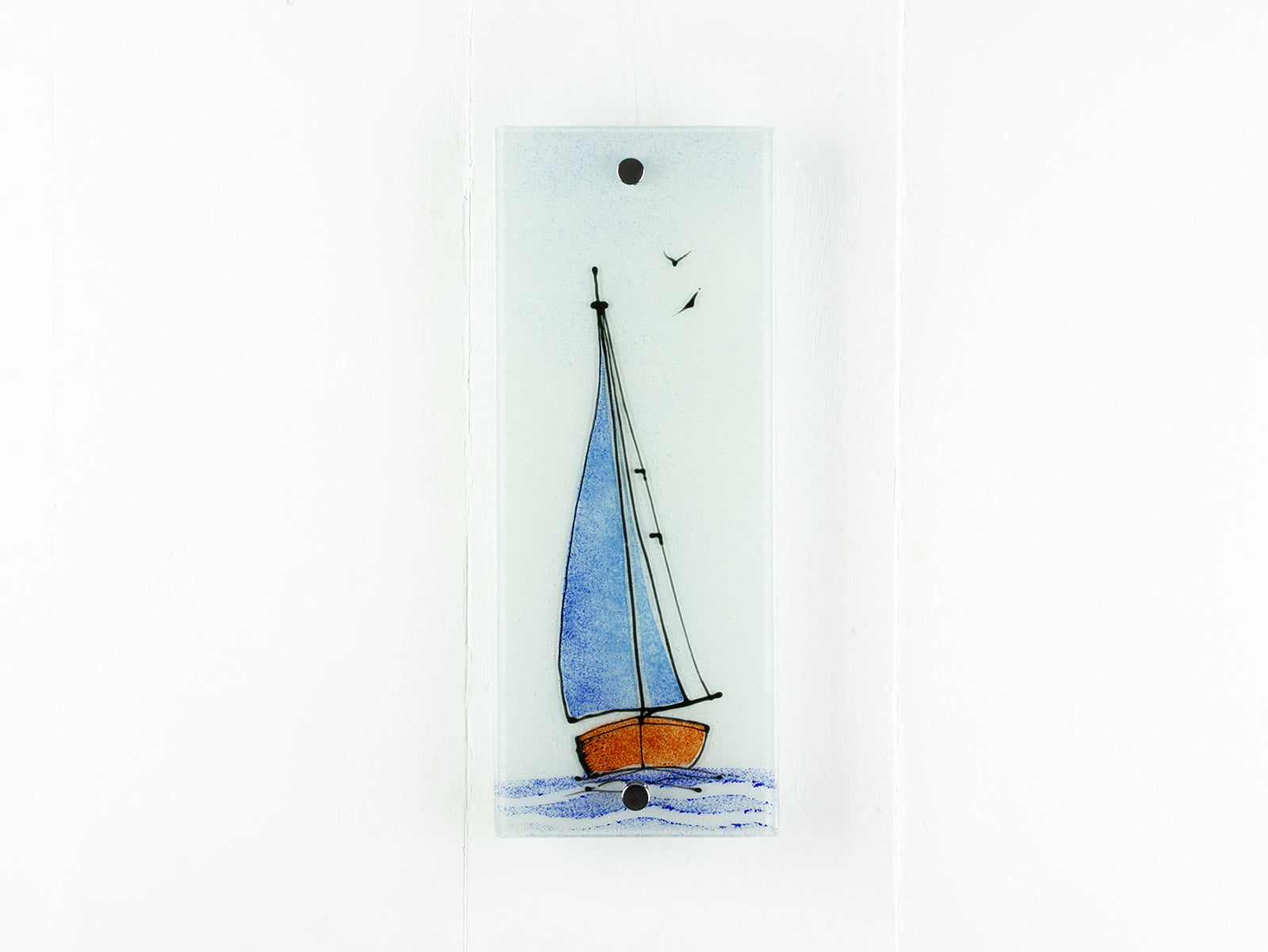 Fused glass wall panel with a sail boat design in soft coastal colours and soaring birds. 