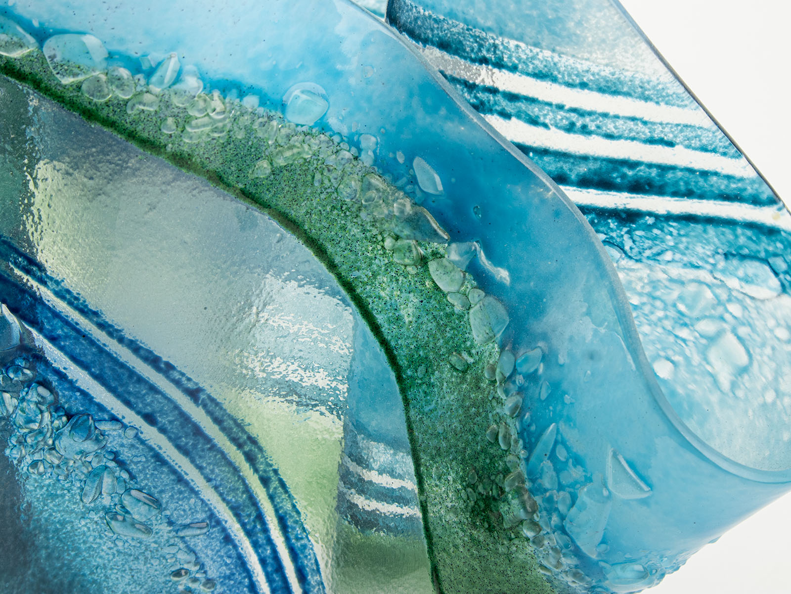 Close up of fused glass large vase handmade in Cornish studio in coastal blue colours. Stunning homeware piece of sculptural glass. 