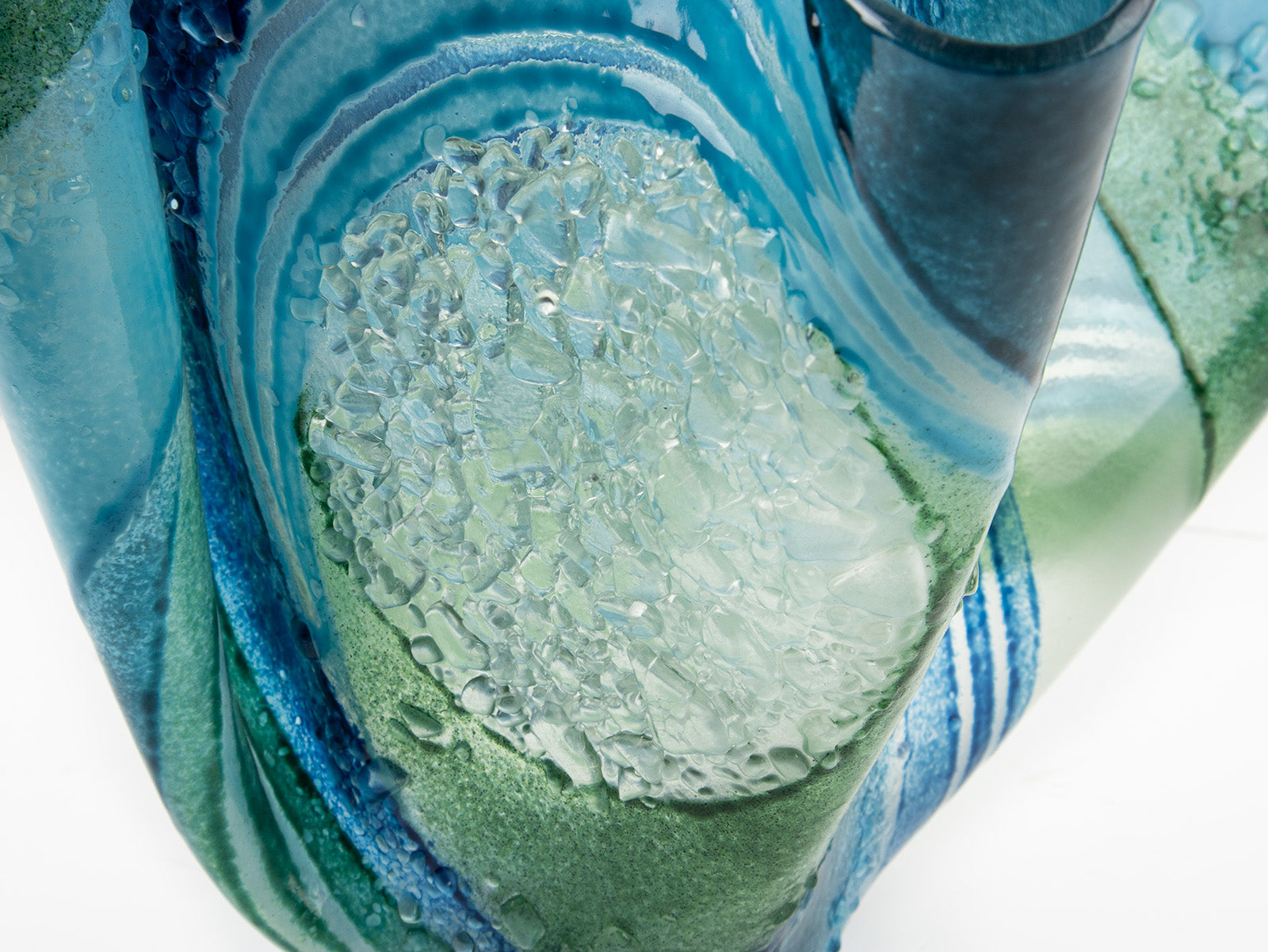 Detailing of Fused glass large vase handmade in Cornish studio in coastal blue colours. Stunning homeware piece of sculptural glass. 