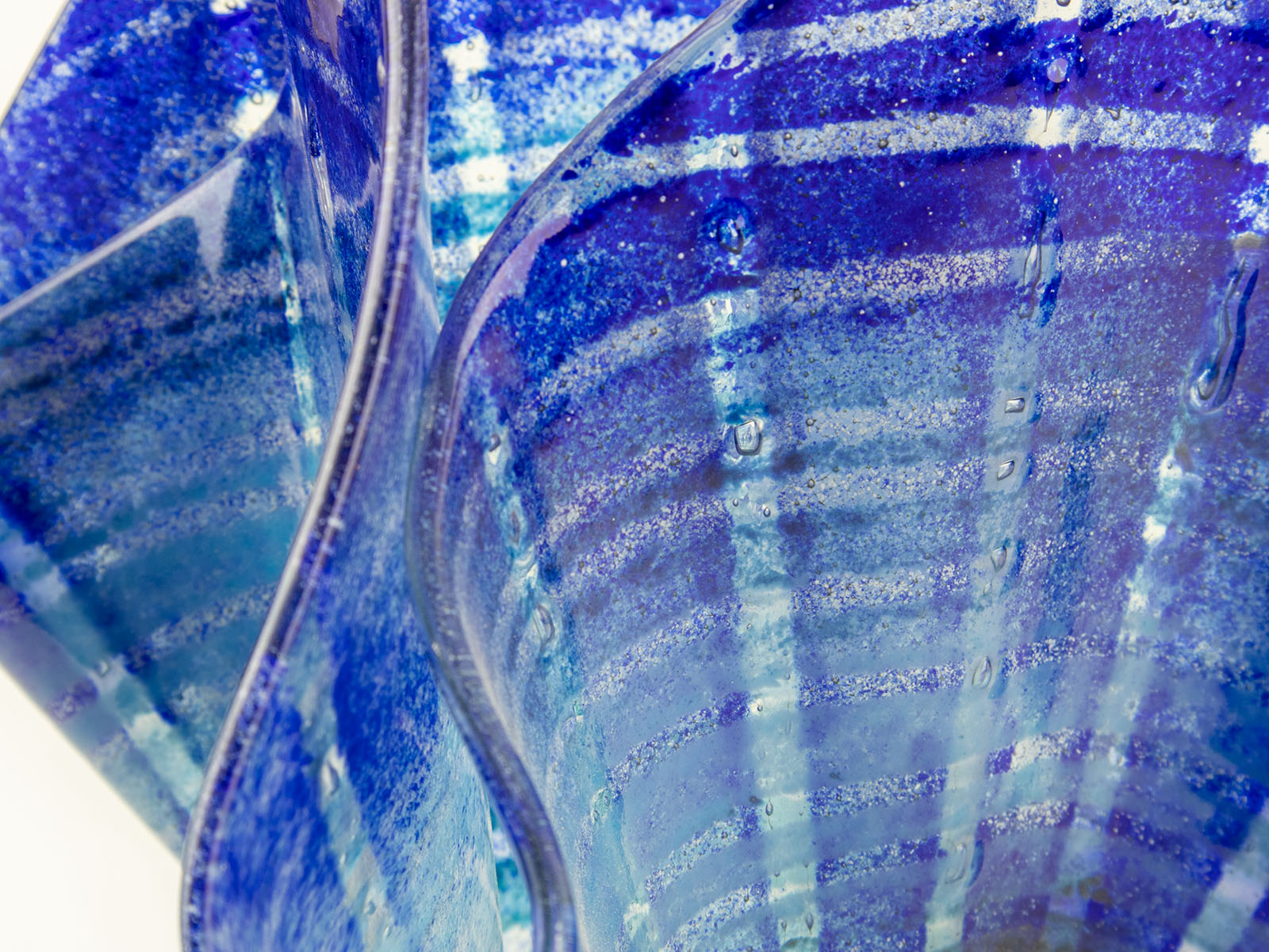 Close up of fused glass large vase handmade in Cornish studio in coastal blue colours. Stunning homeware piece of sculptural glass. 