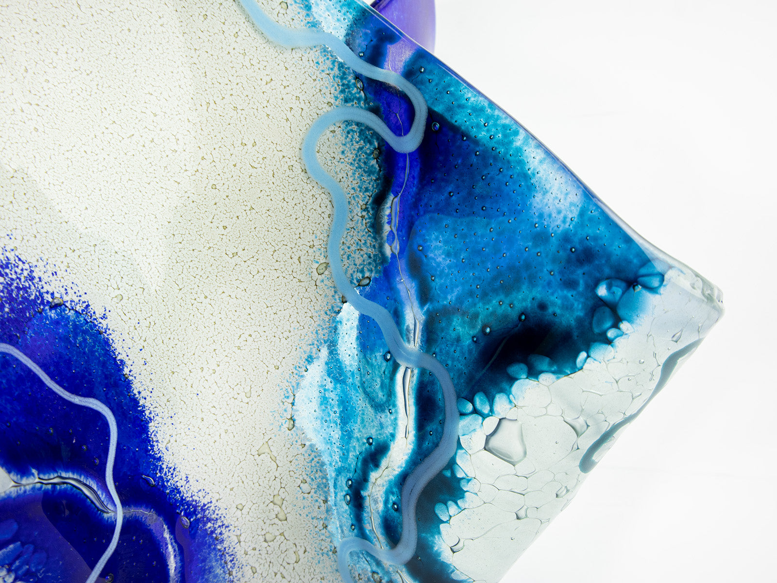 Close up of fused glass large vase handmade in Cornish studio in coastal blue colours. Stunning homeware piece of sculptural glass. 