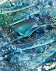 Close-up of blue teal fused glass sqaure bowl textured surface