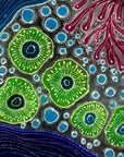 Close up of fused glass round wall panel with hand painted design of a coral reef. Organic and vibrant ocean colours. 