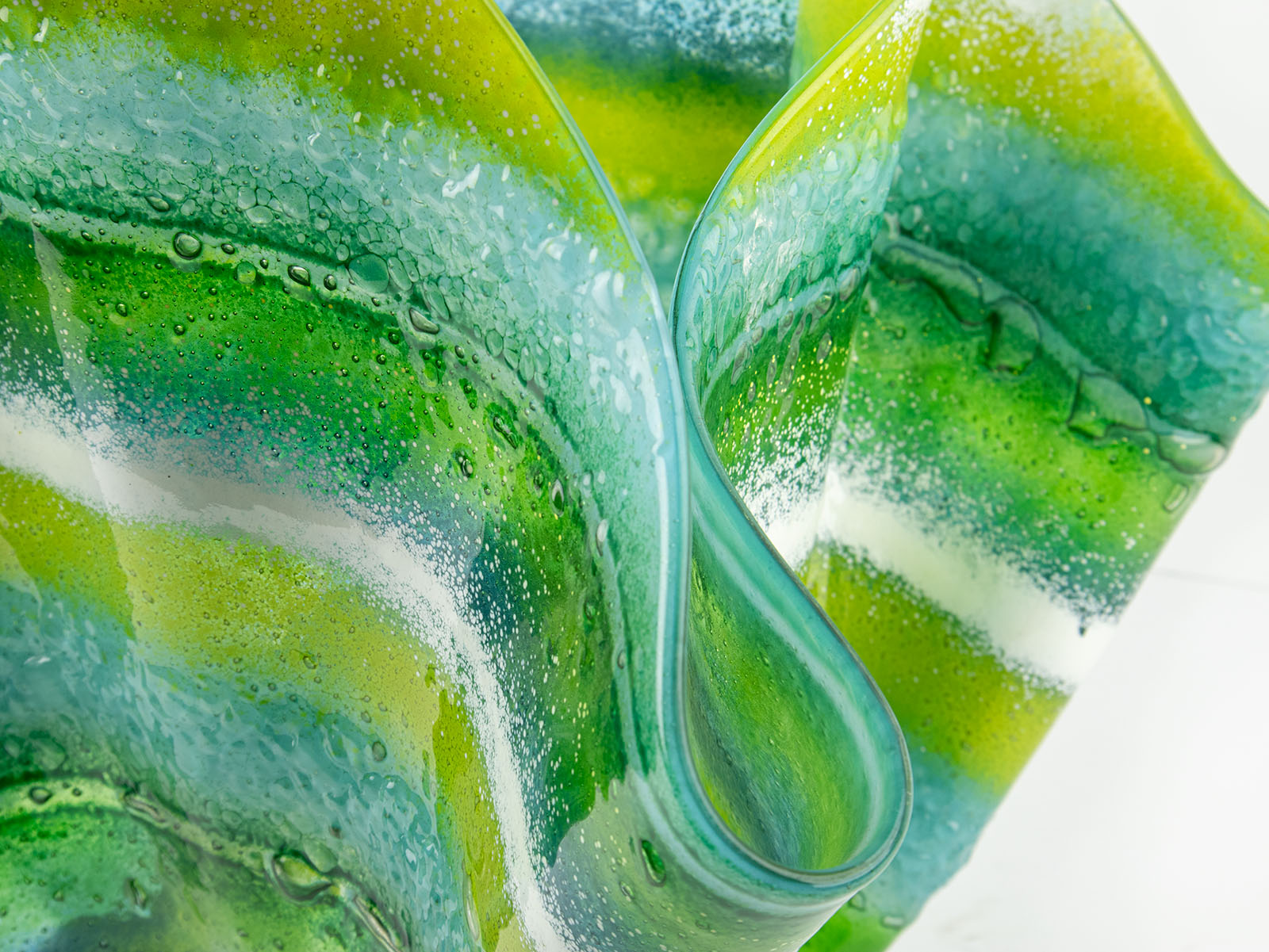 Details of fused glass extra large vase handmade in Cornish studio in coastal green colours. Stunning homeware piece of sculptural glass. 
