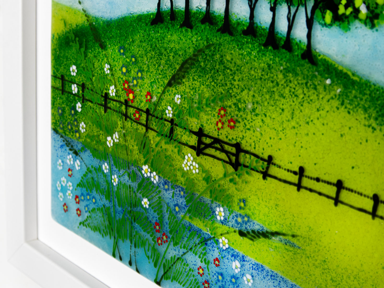 Hand-painted detail on Fused glass art frame with countryside design and vibrant greens.