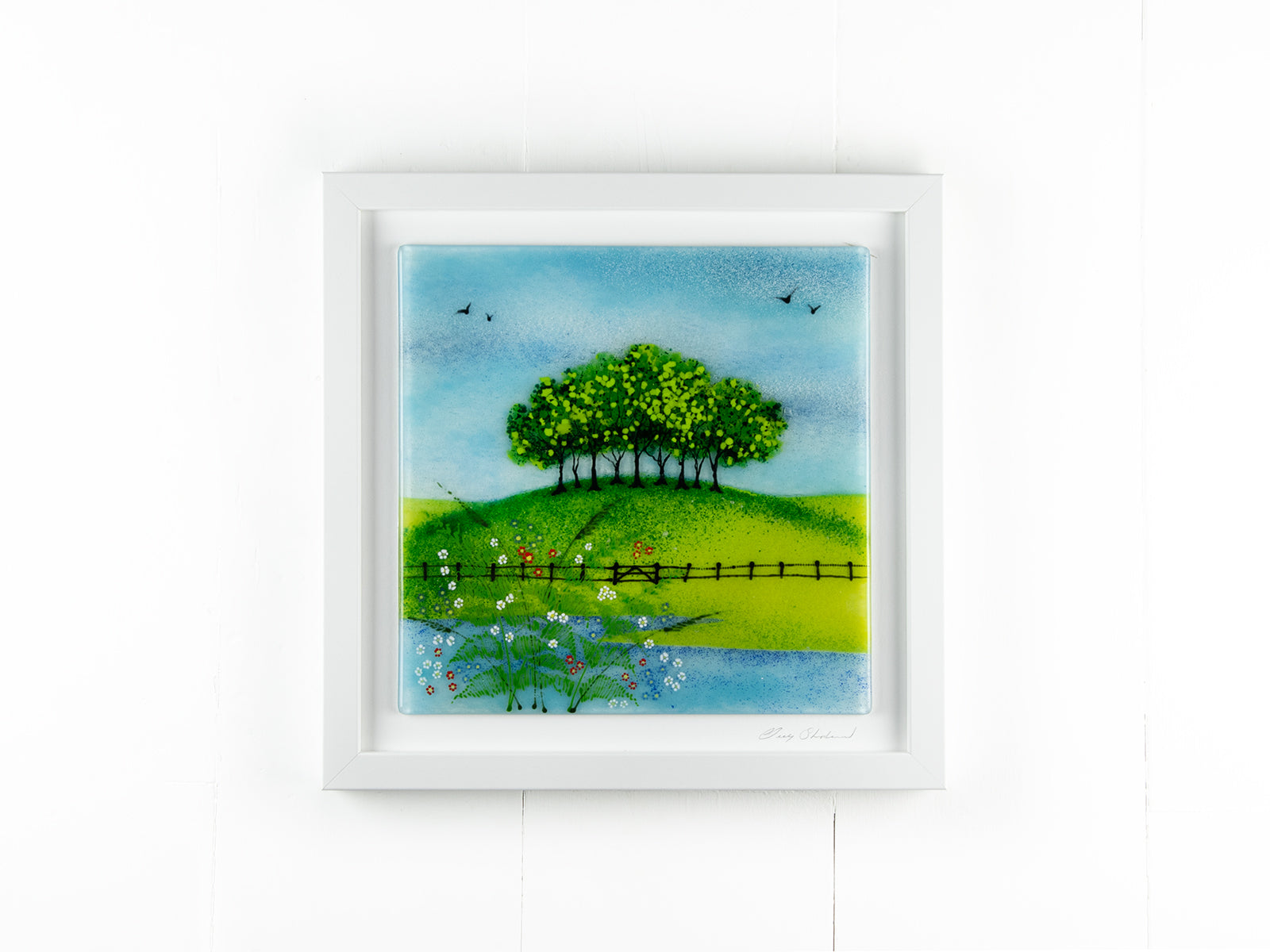 Fused glass art frame with countryside design and vibrant greens.