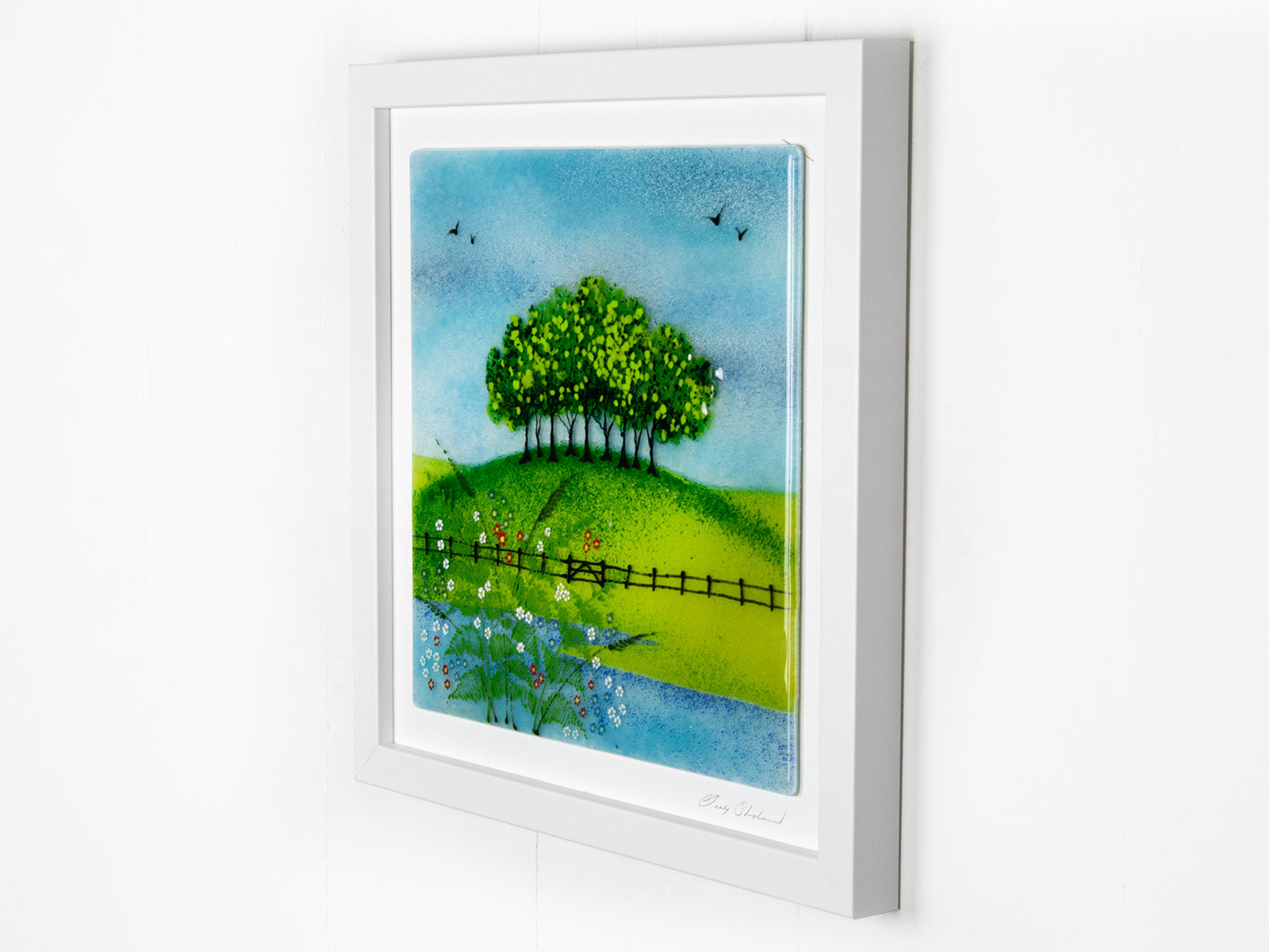 Fused glass art frame with countryside design and vibrant greens.