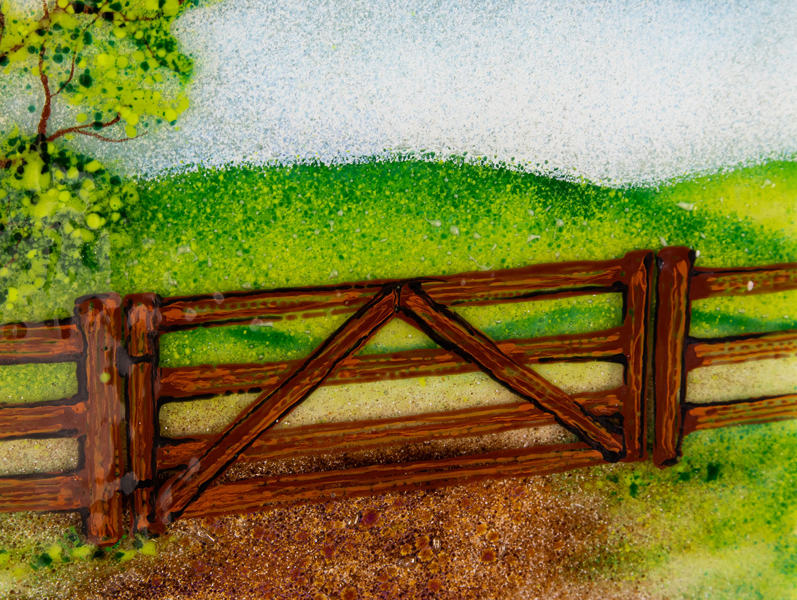 Fused glass art frame with a countryside scene in vibrant colours, focused on a wood gate.
