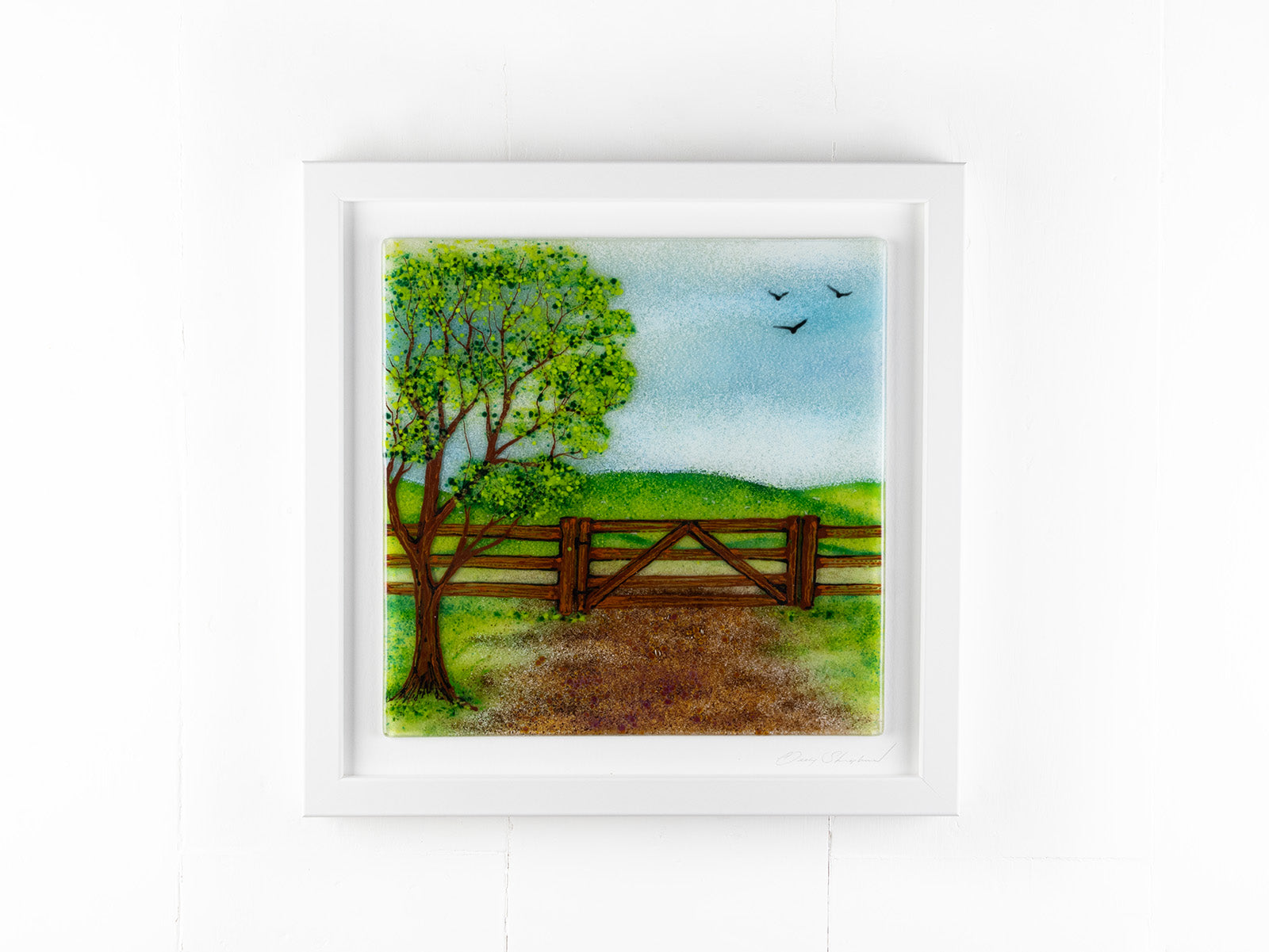 Fused glass art frame with a countryside scene in vibrant colours. 