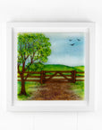 Fused glass art frame with a countryside scene in vibrant colours. 