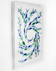 Shoal of fish individually hand-cut in marine blues on white art frame. An ocean inspired piece of wall art. 