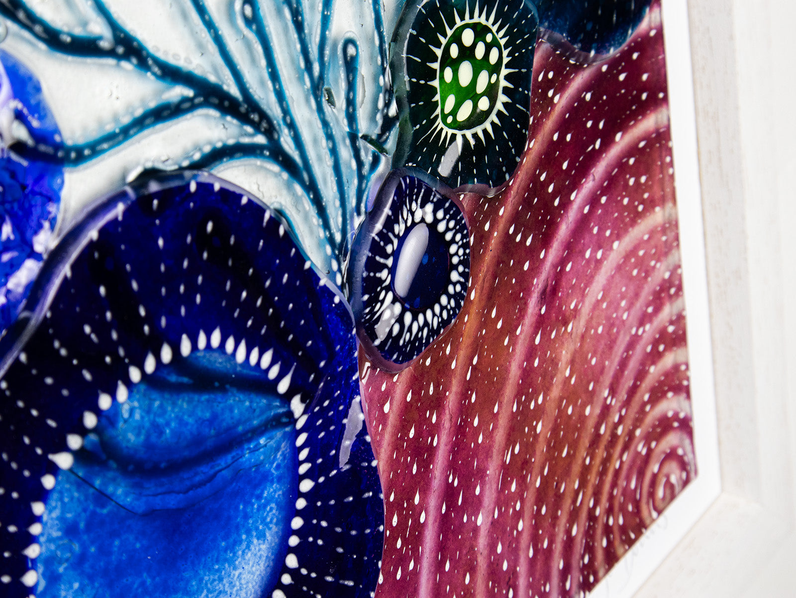 Hand-painted close up of fused glass art frame, in vibrant coastal colours, inspired by the ocean reefs with organic detailing. 