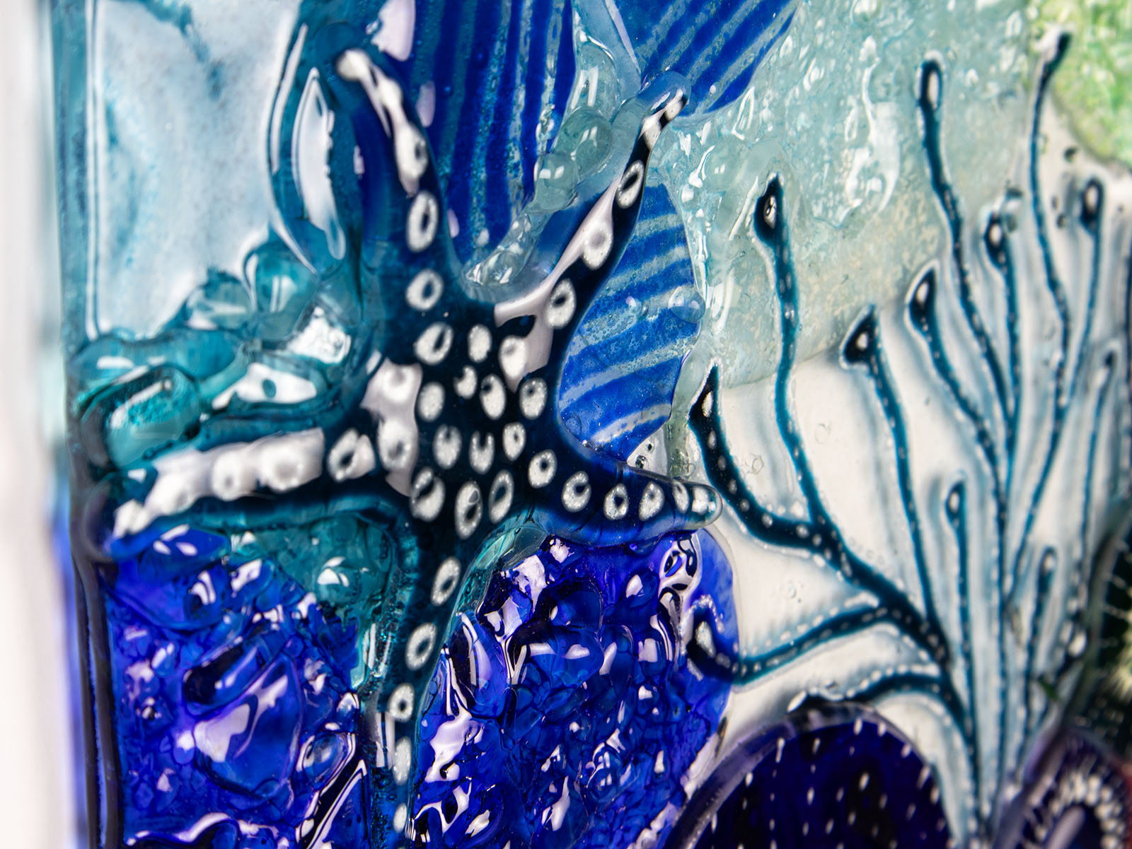 starfish detailing on fused glass art frame, in vibrant coastal colours, inspired by the ocean reefs with organic detailing. 