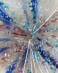 Textured details of fused glass circular panel featuring soft, coastal colours.