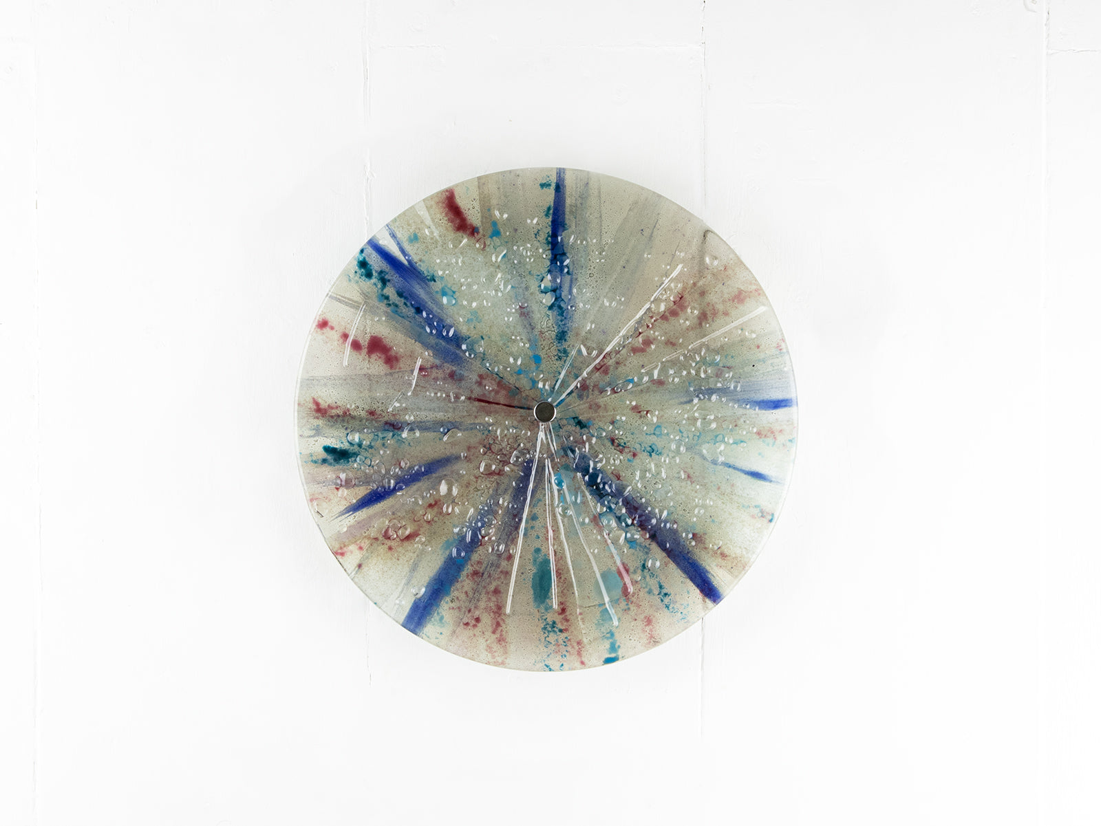 Fused glass circular panel featuring soft, coastal colours.