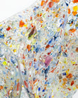 Close up of a fused glass extra large fold form vase, made from multi coloured, recycled glass frit. 